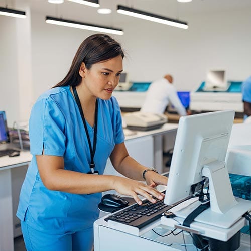 Image of female physician working on computer