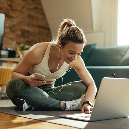 Woman in activewear using laptop