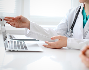 Physician working with computer